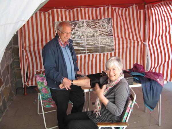 Rotarian Dr Bob Bevington checks a patient's blood pressure.