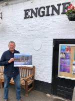Photograph of Ted of The Engine Public House with the Kenilworth Advent Calendar.

