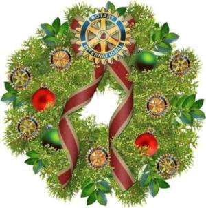 A Christmas wreath bearing the Rotary logo