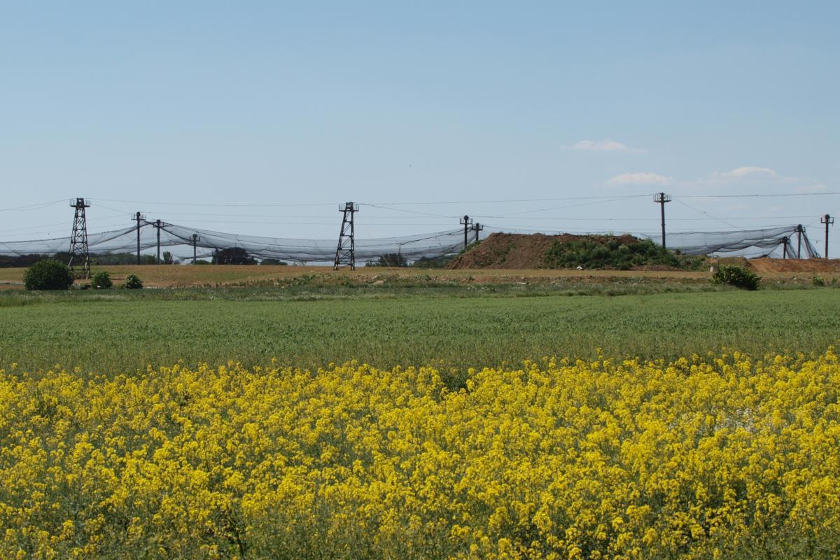 Looking over a field to a large garbage area