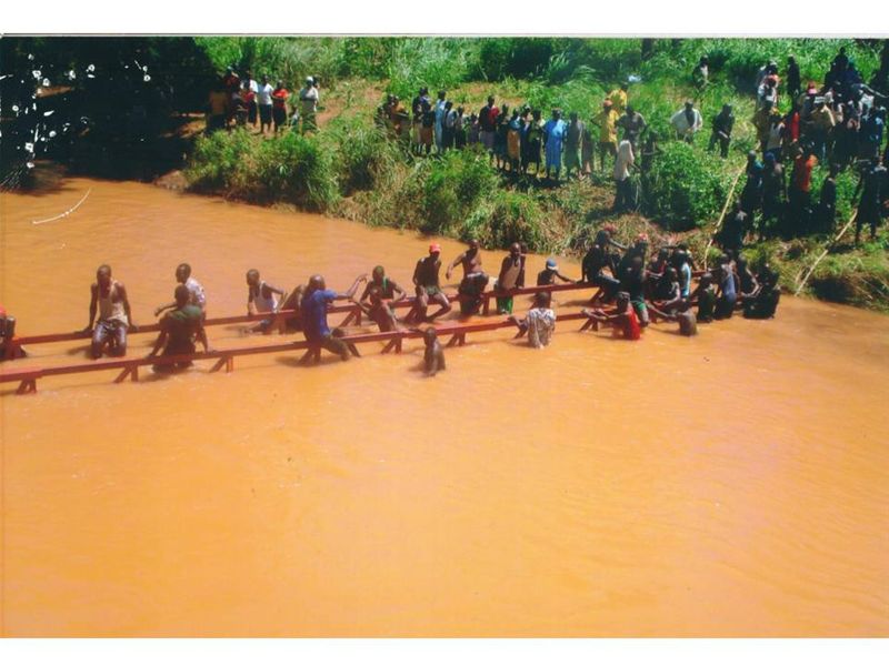 The villagers rebuilding their bridge