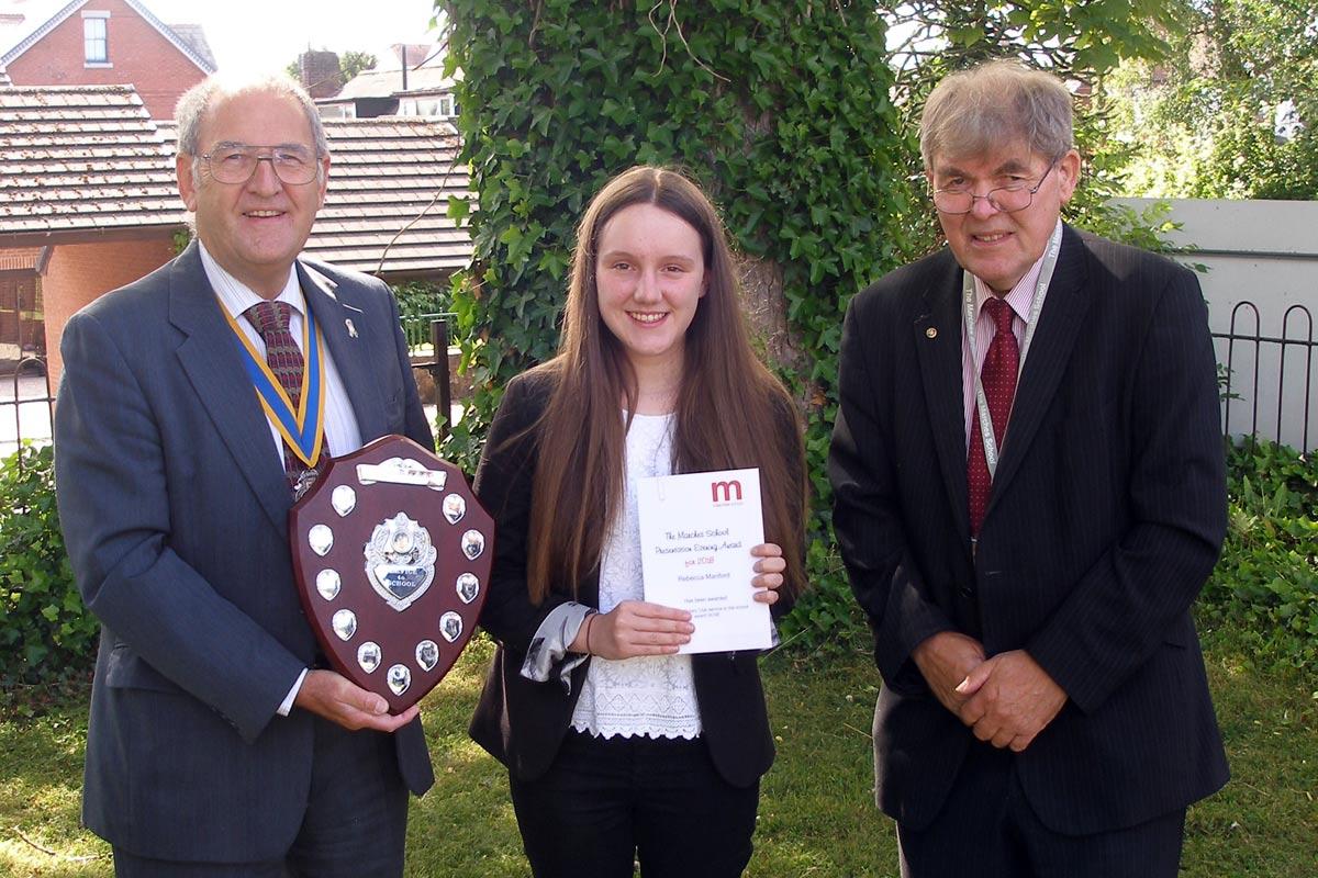 President David Davies (L) and Chairman of The Marches Local Governing Body Mark Liquorish (R) present the award to Rebecca Manford
