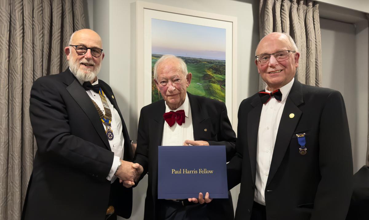 Tom Farley is presented with a Paul Harris Fellowship for his service to the club over 36 years.