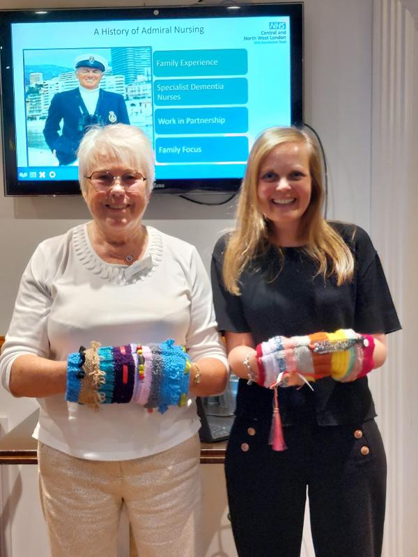 Lindsay The Admiral Nurse for Hillingdon is presented with Fiddle Muffs by Rotary Member Brenda