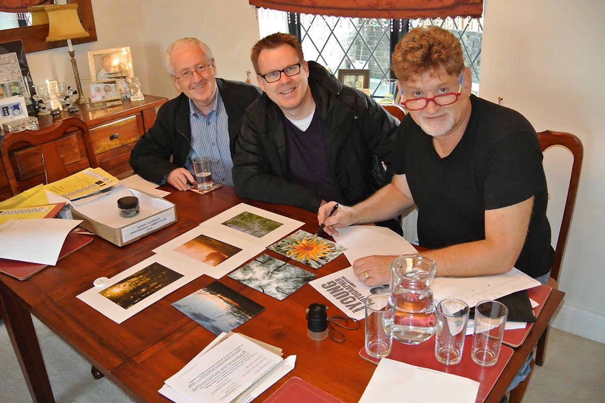 The Judges examine each photograph