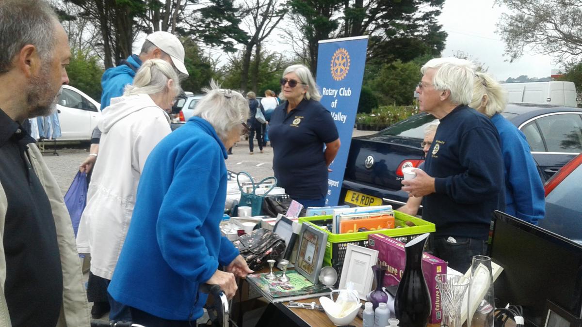 Rotarians Bob and Lyndsey (with Jacqui hidden) sell on unwanted goods 
