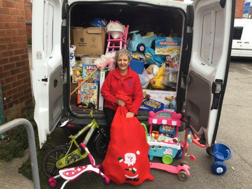 Rotarian Linda with a full van of donated toys delivered to Refuge HQ