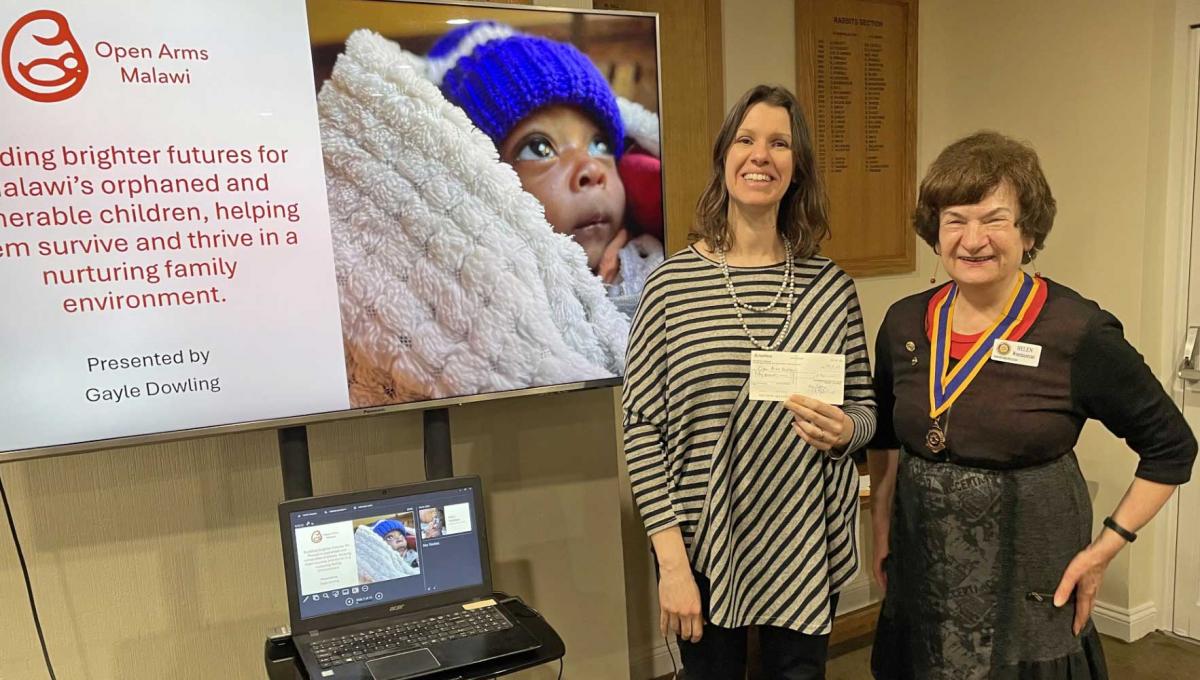 Photo shows Gayle Dowling from Open Arms Malawi receiving a donation from Knaresborough Rotary President Helen Westmancoat.