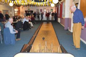 Gordon Peel bowls, President Jim and others look on.