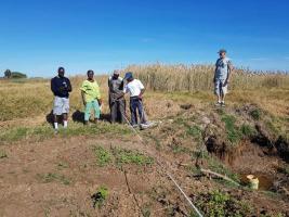 Local workers starting to survey the drainage route