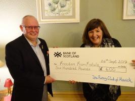 Foundation Convenor Gus Neilson hands over the Club's donation to Sue Hope of FFF.