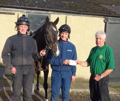 Cheque for £250 presented to jockey Craig Nichol for The Injured Jockeys Fund