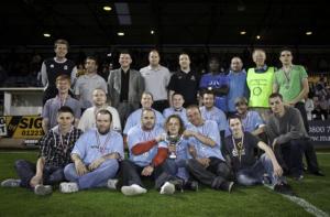 Representatives of Wintercomfort and YMCA teams with officials after the presentation.