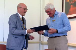 John Davies is presented with a Paul Harris Fellowship by President Ian