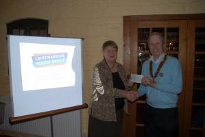 Patrick presents Sheila with a donation for LYG