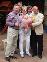 Past President Peter Mehta (right) presents Anne and Alan Rankin with Flowers, watched on by Alan Skilling and Derek Anderson