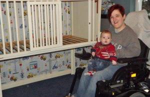 A cot adapted for a disabled mother