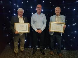 Club President Angus receives the award from District Governor Martin Bye