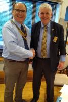 Simon Flint hands over the Presidential regalia to Simon Goodale