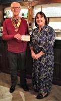 President David Brown presenting a cheque to CVS CEO Debbie Gibbon at their monthly social gathering (3rd Tuesdays) at The Pheasant Inn, Admaston.