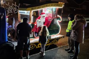 Santa giving a lucky girl an early Christmas present (courtesy of her parents)