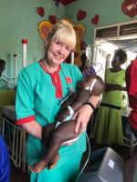Helping care for a sick child in Uganda
