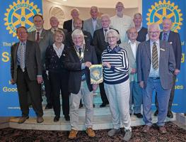 President Sandy Farquharson presents a club banner to Adrienne Williams