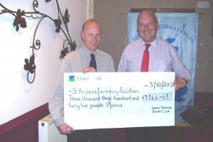 Peter Palmer receives cheque from Snr Vice Nigel Driver