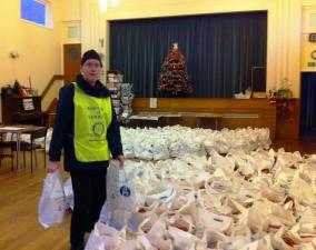 Rotarian Eddie Webb in a sea of  NWN Over 80's Xmas parcels
