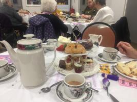Previous guest enjoying their tea, whilst supporting a good cause