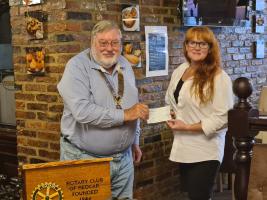 President Dave Tabner presenting Sophie Baxter of Going 4 Independence with £150