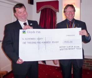 President Steve hands over the monster cheque to Adrian William of the Alzheimers Society