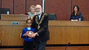 Winner receiving her trophy and prizes from the Mayor of Oldham