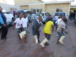 Children at Butterfly House in Paarl SA show how a gum boot dance is done