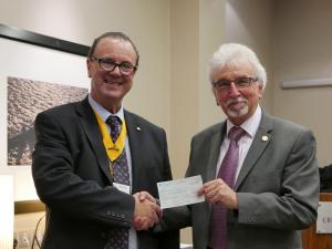 Berkshire Vision's Tom Conlin receives a Â£200 cheque from Reading Abbey Rotary Club