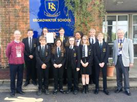 Entrants from Busbridge Junior School having been presented with their certificates., The winner, Sophie, is fourth from the left in the front row. Also pictured from Woolsack are President Simon Crowther (left) and Tim Kendall, event organiser.