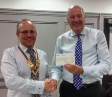 President Carl Watson presents a cheque for £600 to BuildAid to DG Nick Sillitoe