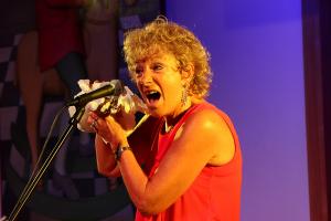 Morag using a plastic bag to create the "noise" of a 78rpm recording while singing..