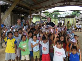 Cass, Helen with the children of Paltacocha after the Christmas present drop.