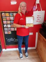 Owner Catherine Turley-Long is presented with the trophy in her shop