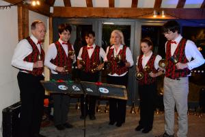 A group of hand bell ringers at Christmas party in Boughton