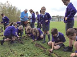 Children receiving and planting