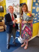 Roary Club President George Paulson presents flowers and a leaving card to Clare Wingrave.