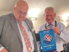 DG David Morris (Left) presents the pennant of RI President Shekhar Mehta to Club President Mike Harris