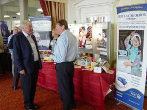 In the foreground Bury Rotarian Nigel Danby discusses with Past District Governor Colin Incet the Rotary Shoe Box scheme whilst in the background Peter Clare chats to Past District Governor Stan Bowes watched by fellow trustee Mrs Gill Danby