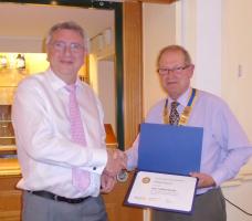 Ashley Weaver being presented with a Paul Harris Fellowship by President Rod Stokes
