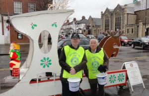 Cold & Wet Rotarians on Santa's Sleigh collecting in the rain