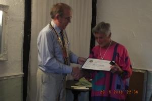 Outgoing President Robin presents a Paul Harris award to Nora Arnold