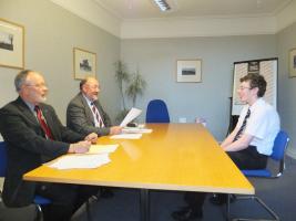 Rotarians Ian Wilcock and Roy Hunter prepare to interview a Crieff High School participant 