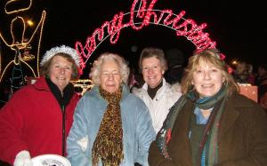 Dorothy Dye (far left) and Lucia Mahew (far right) provide a warm welcome to everyone!